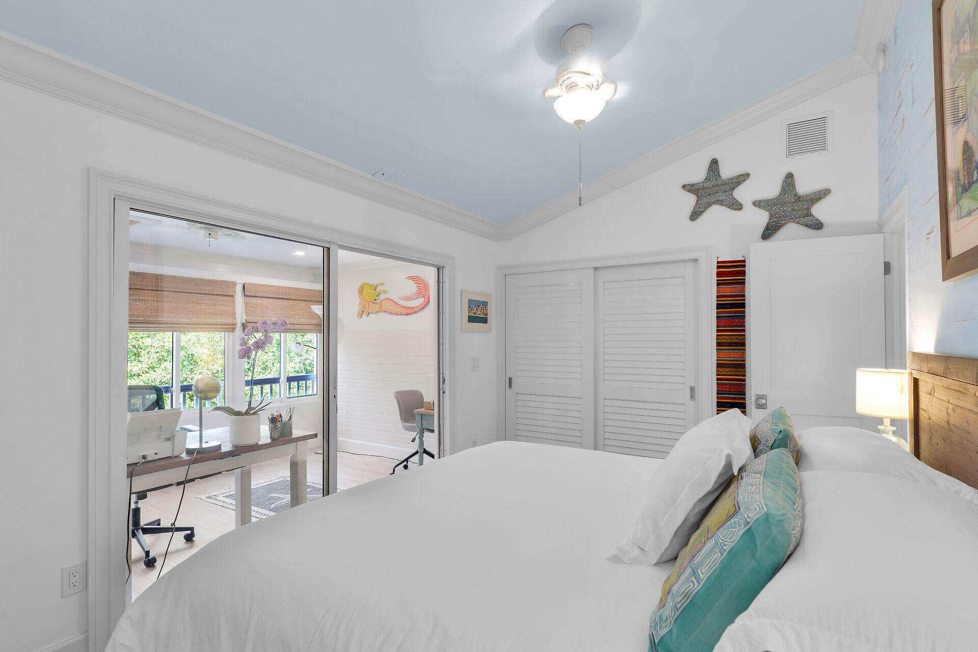 21 Whistling Duck Lane Key West, FL 33040 - Photo 26 of 45 a bedroom with a bed and a chandelier