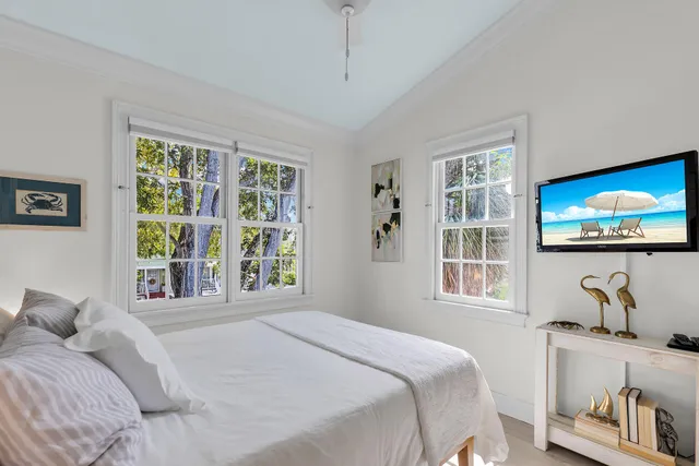 a bedroom with a bed and a flat screen tv