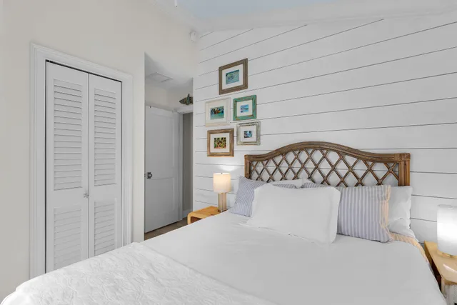 a bedroom with a bed and painting on the wall