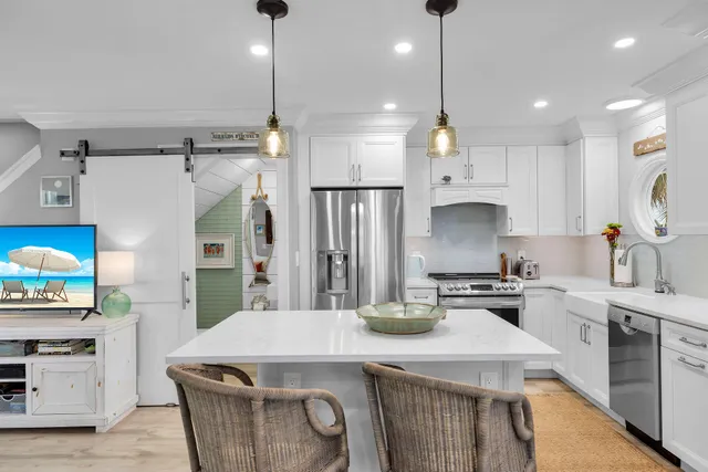 a kitchen that has a lot of cabinets in it and appliances