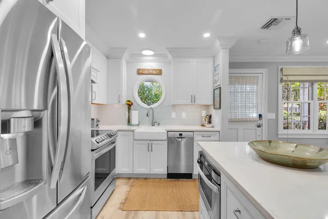 a kitchen with a sink stove and refrigerator