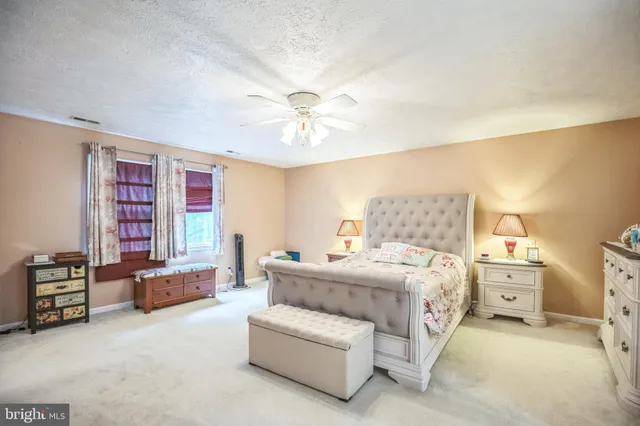 a bedroom with a bed and flat screen tv