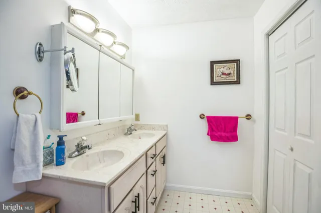 a view of a hallway with wooden floor and furniture