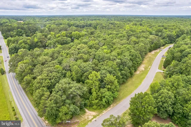 an aerial view of a house with swimming pool and garden