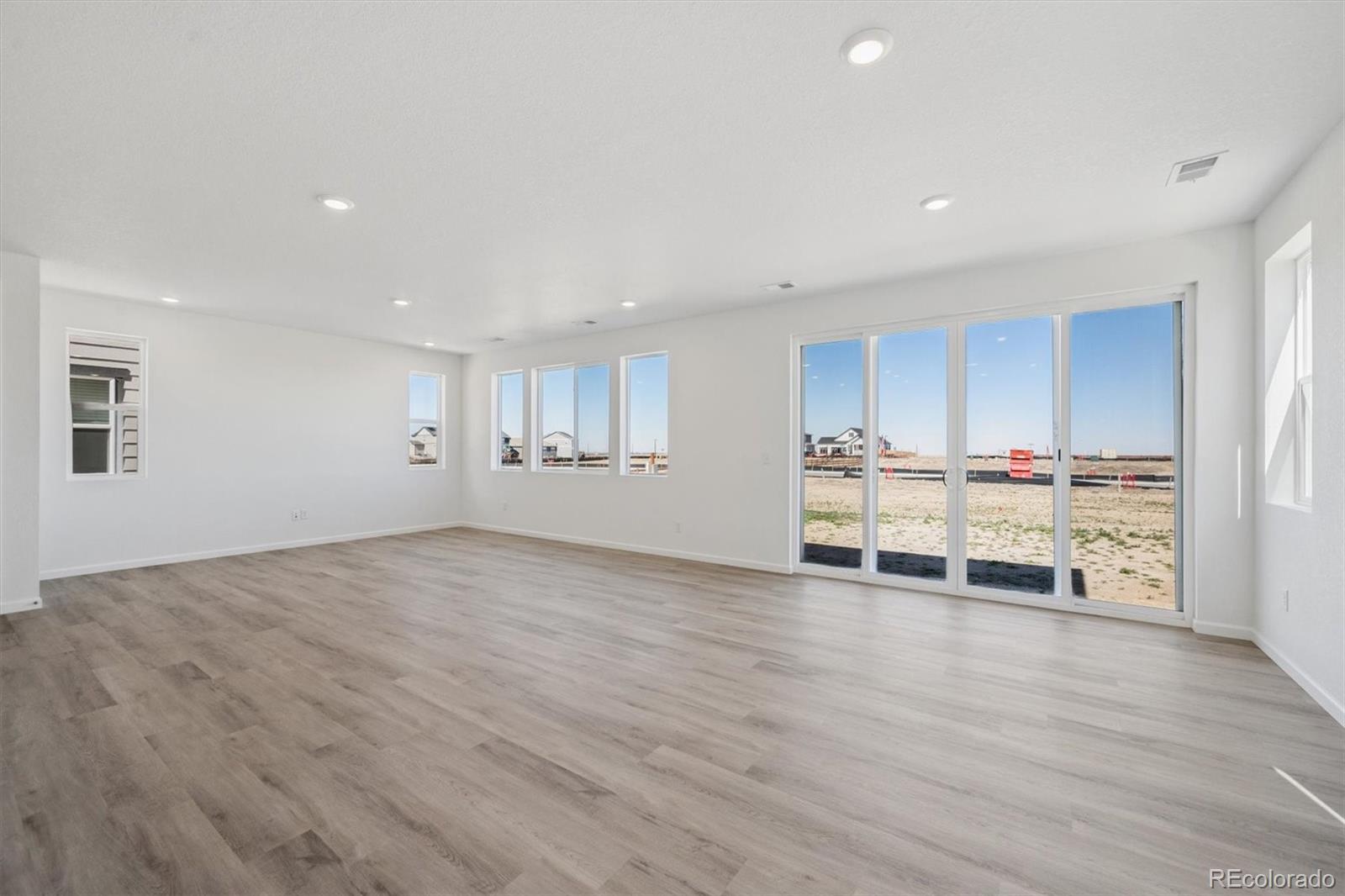 45935 Gentry Avenue Bennett, CO 80102 - Photo 11 of 22 a view of a room with wooden floor and window