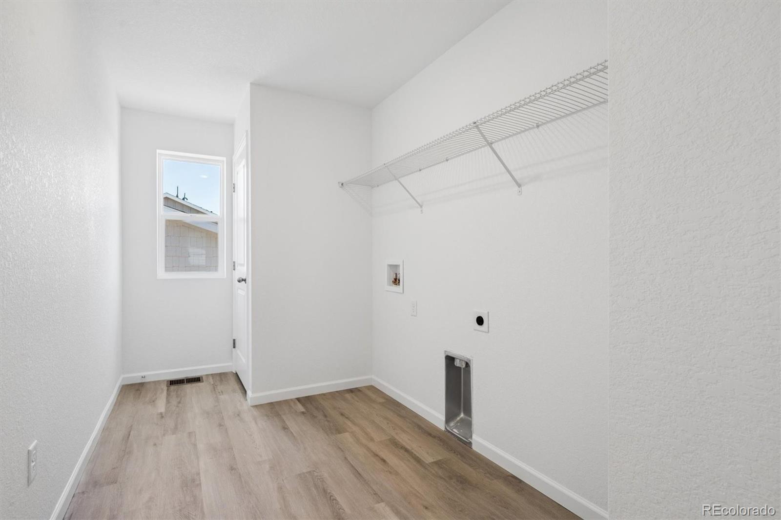45935 Gentry Avenue Bennett, CO 80102 - Photo 15 of 22 a view of small space with wooden floor