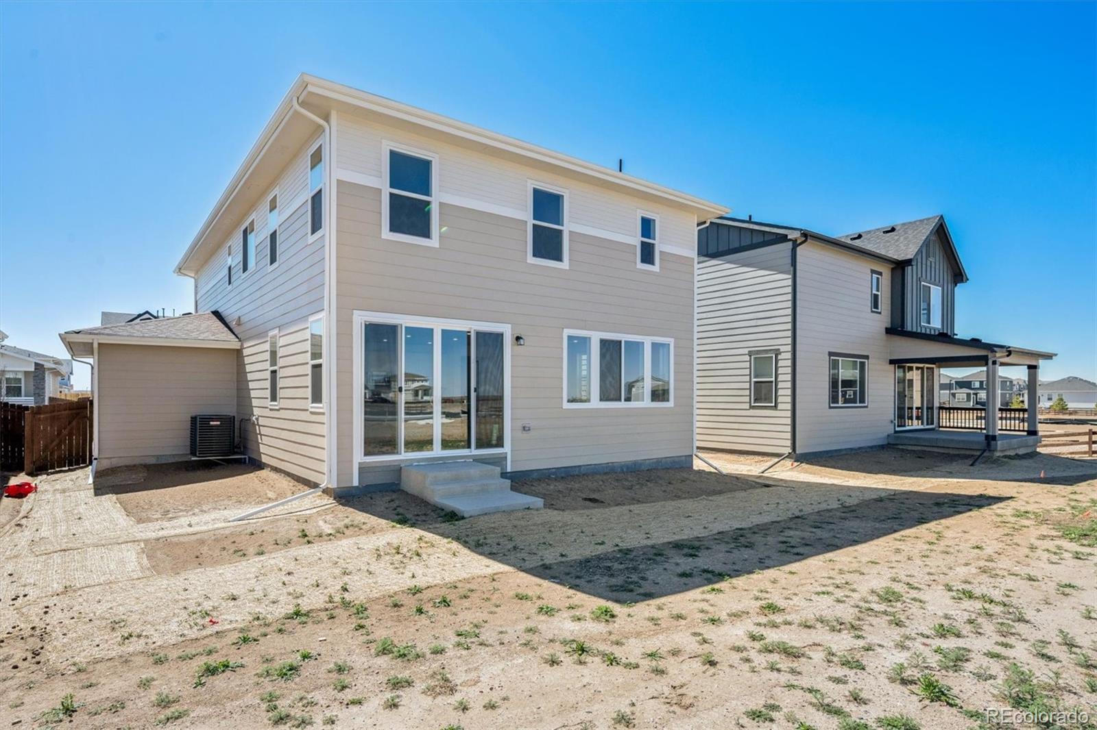 45935 Gentry Avenue Bennett, CO 80102 - Photo 19 of 22 a front view of a house with a yard