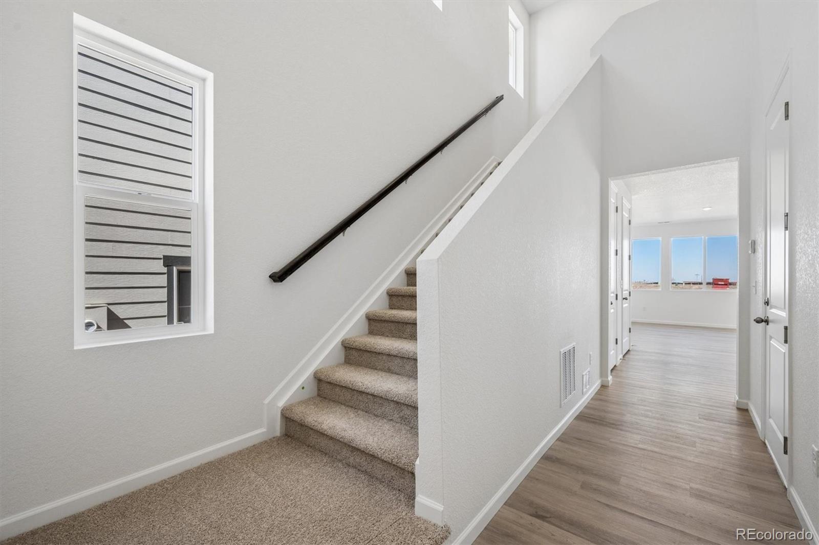 45935 Gentry Avenue Bennett, CO 80102 - Photo 3 of 22 a view of a hallway with wooden floor and entryway