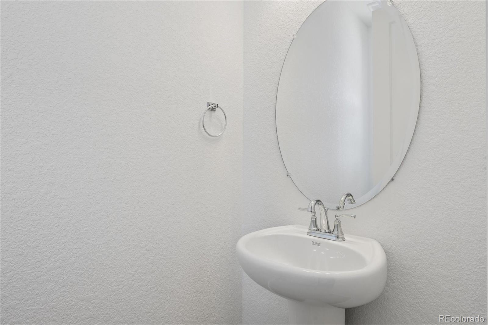 45935 Gentry Avenue Bennett, CO 80102 - Photo 4 of 22 a bathroom with a sink and mirror