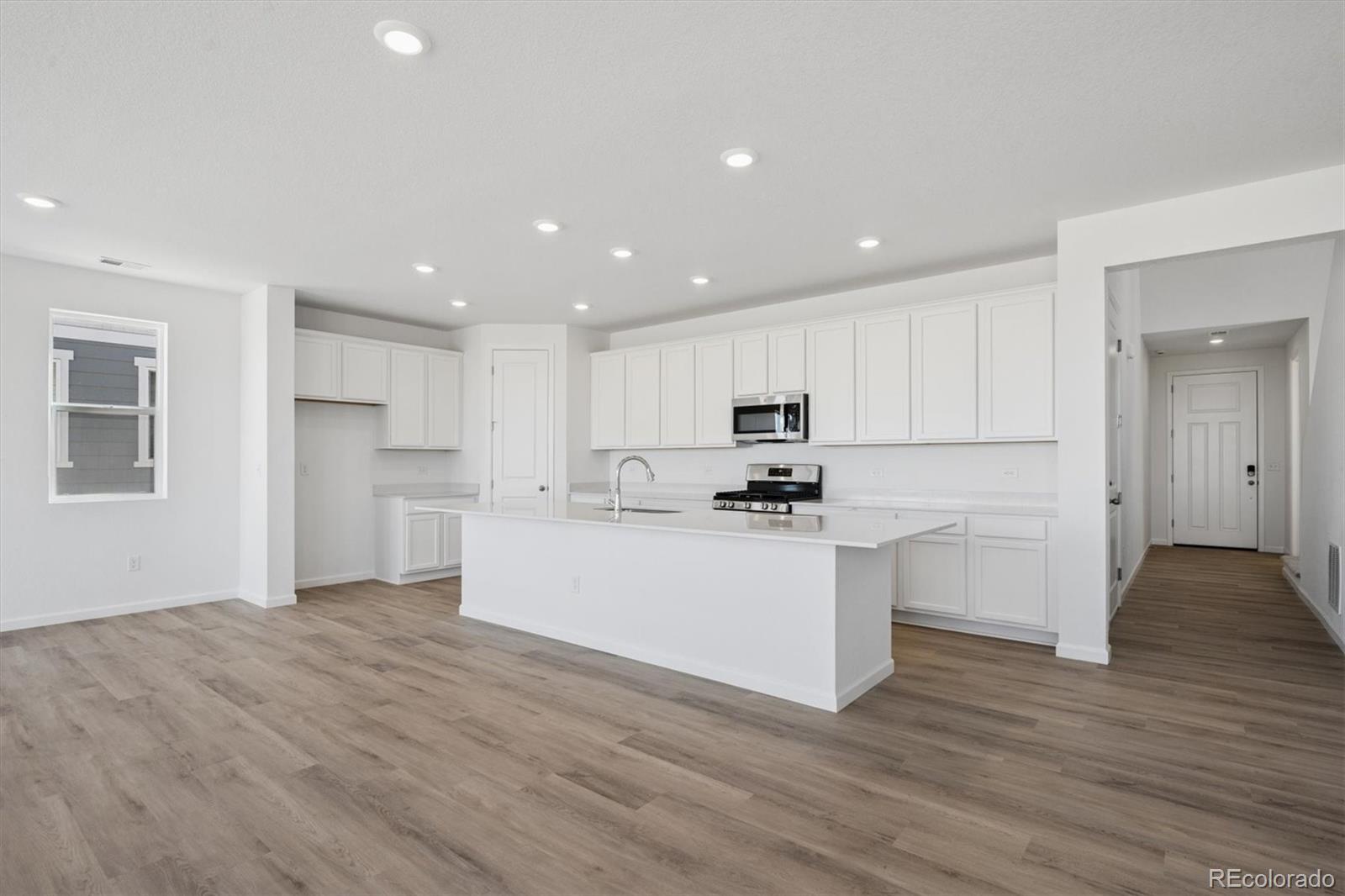 45935 Gentry Avenue Bennett, CO 80102 - Photo 6 of 22 a view of kitchen with wooden floor