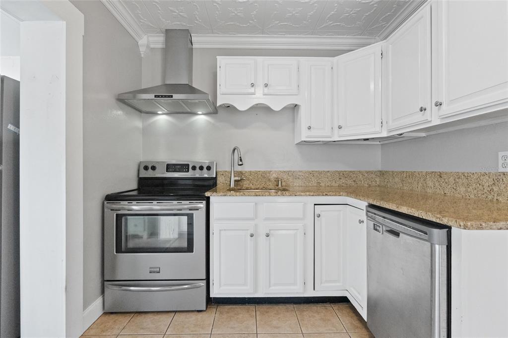 1603 Tulane Street Orlando, FL 32804 - Photo 7 of 27 a kitchen with white cabinets and white appliances