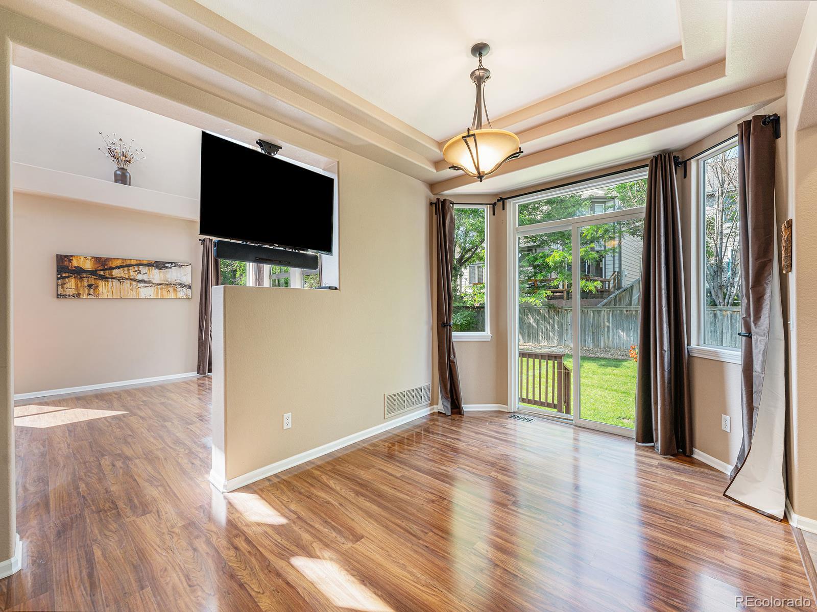9911 Sylvestor Road Highlands Ranch, CO 80129 - Photo 11 of 31 a view of empty room with wooden floor and fan