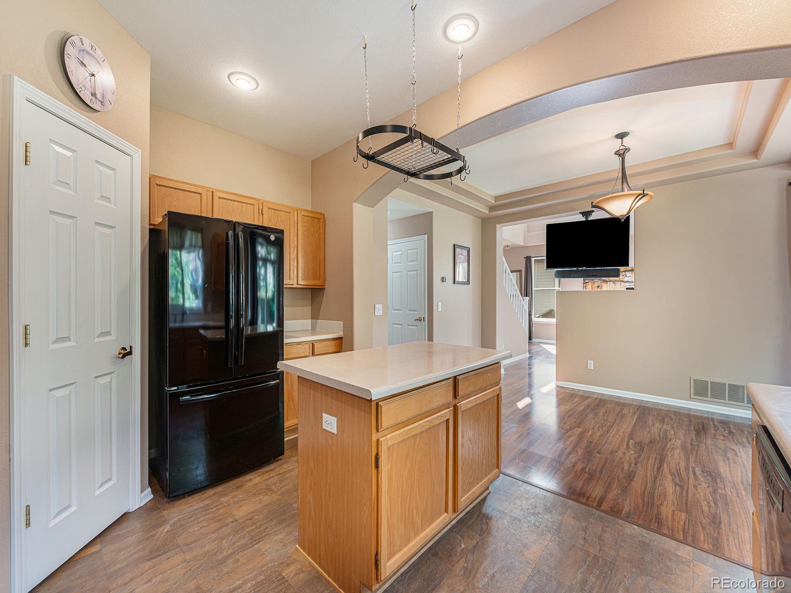 9911 Sylvestor Road Highlands Ranch, CO 80129 - Photo 13 of 31 a kitchen with stainless steel appliances granite countertop a refrigerator a sink and a stove