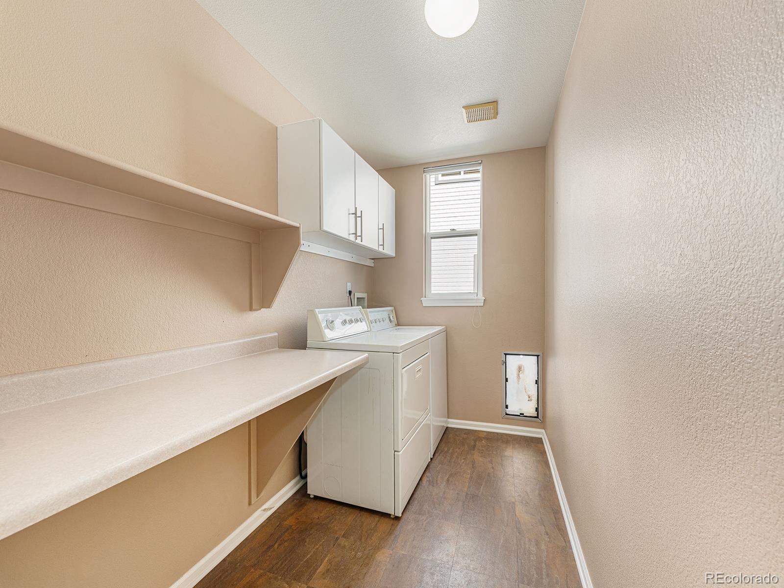 9911 Sylvestor Road Highlands Ranch, CO 80129 - Photo 16 of 31 a kitchen with a sink a window and cabinets