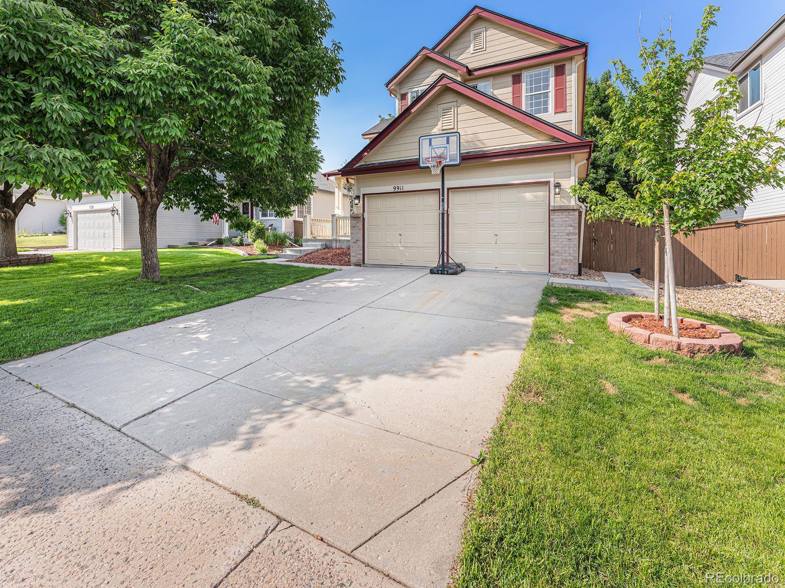 9911 Sylvestor Road Highlands Ranch, CO 80129 - Photo 2 of 31 a view of a house with a yard and tree