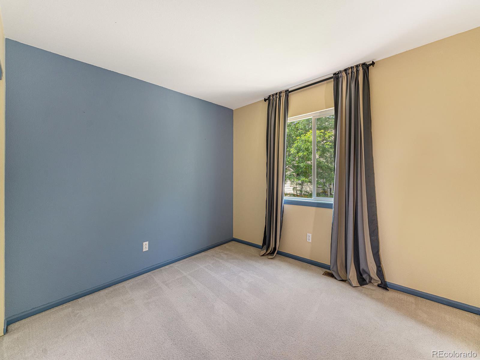 9911 Sylvestor Road Highlands Ranch, CO 80129 - Photo 22 of 31 an empty room with a window