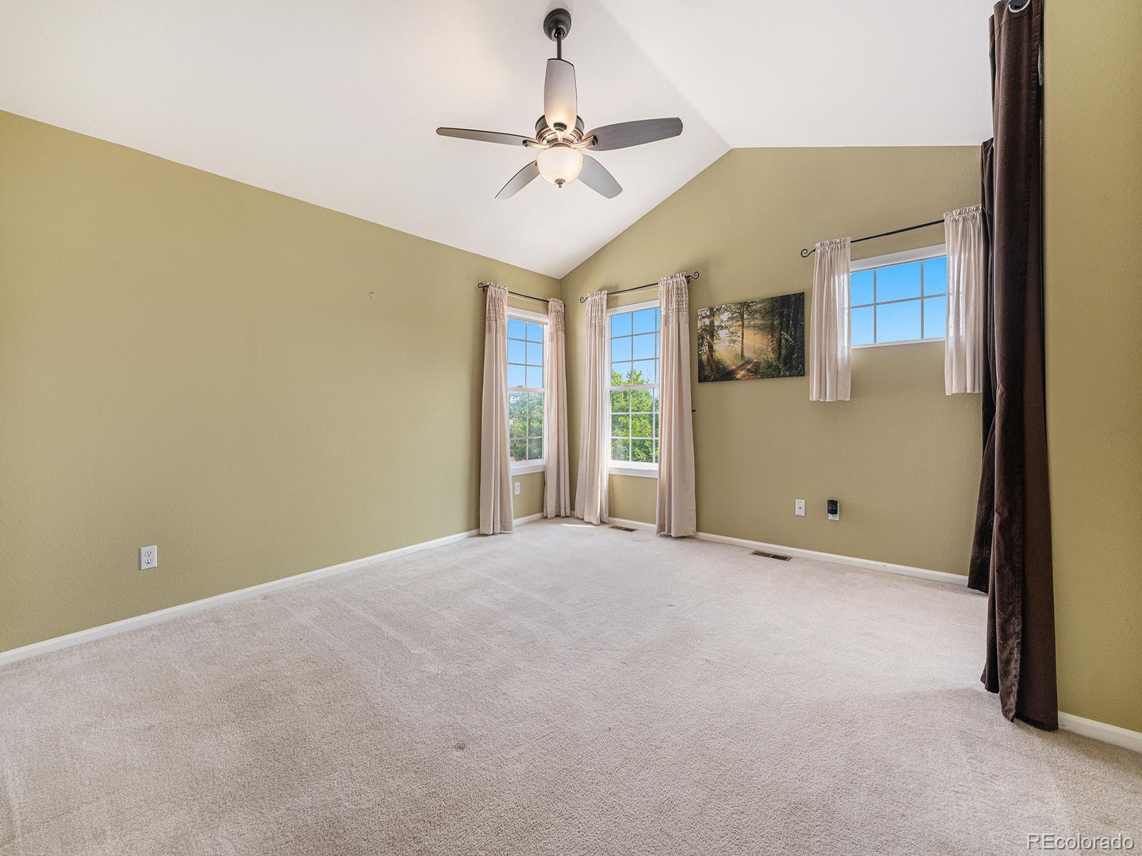 9911 Sylvestor Road Highlands Ranch, CO 80129 - Photo 23 of 31 a view of a room with a ceiling fan and window