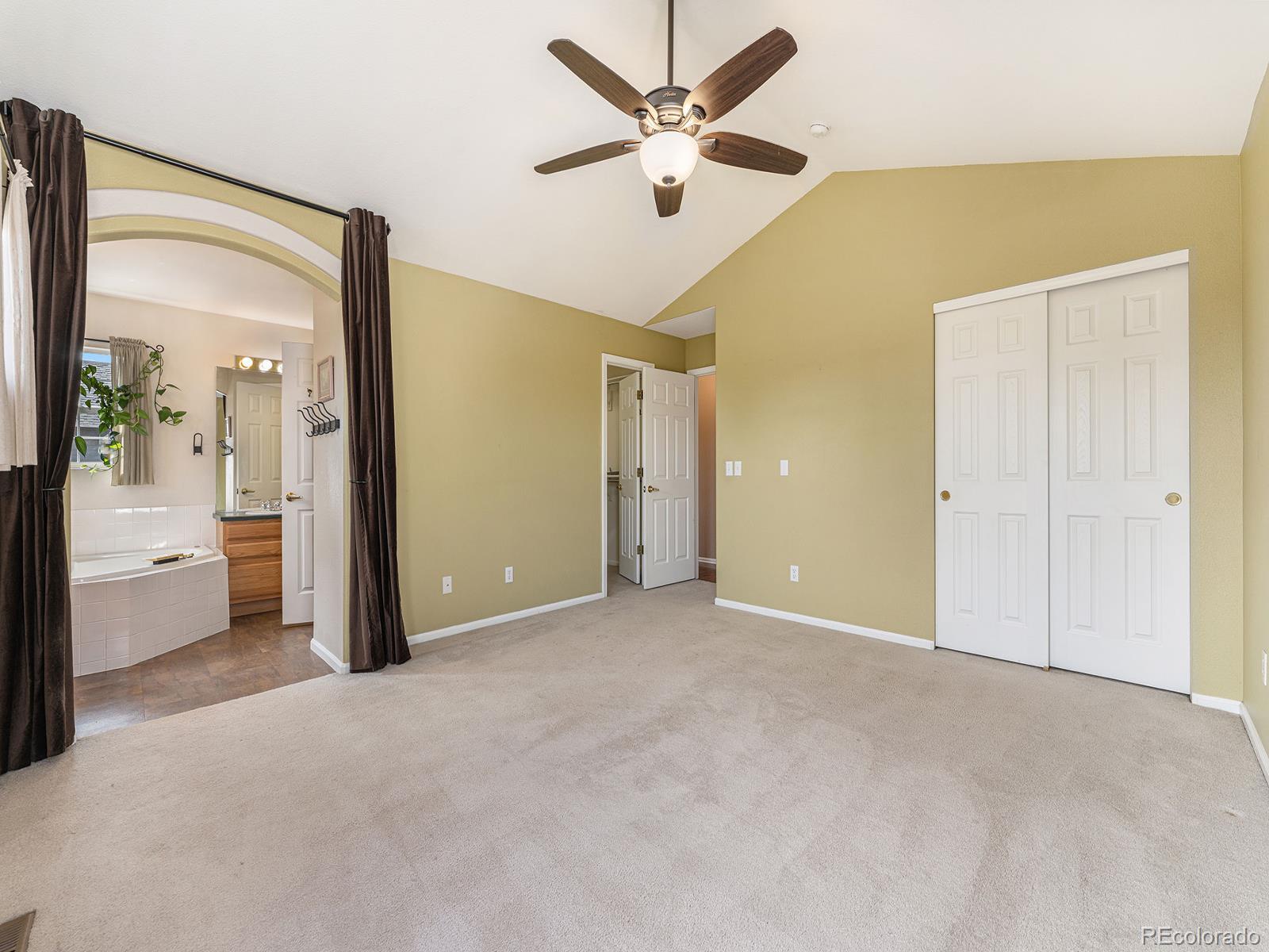 9911 Sylvestor Road Highlands Ranch, CO 80129 - Photo 24 of 31 a view of a livingroom with a ceiling fan & a ceiling fan