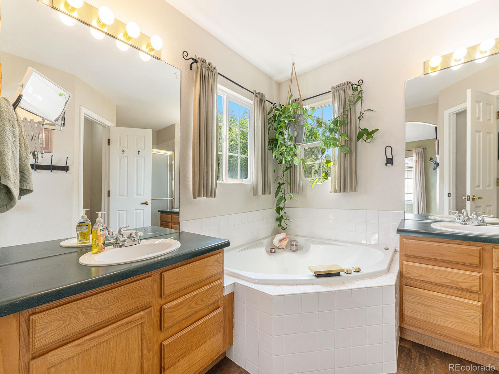 9911 Sylvestor Road Highlands Ranch, CO 80129 - Photo 26 of 31 a bathroom with a granite countertop sink and a mirror