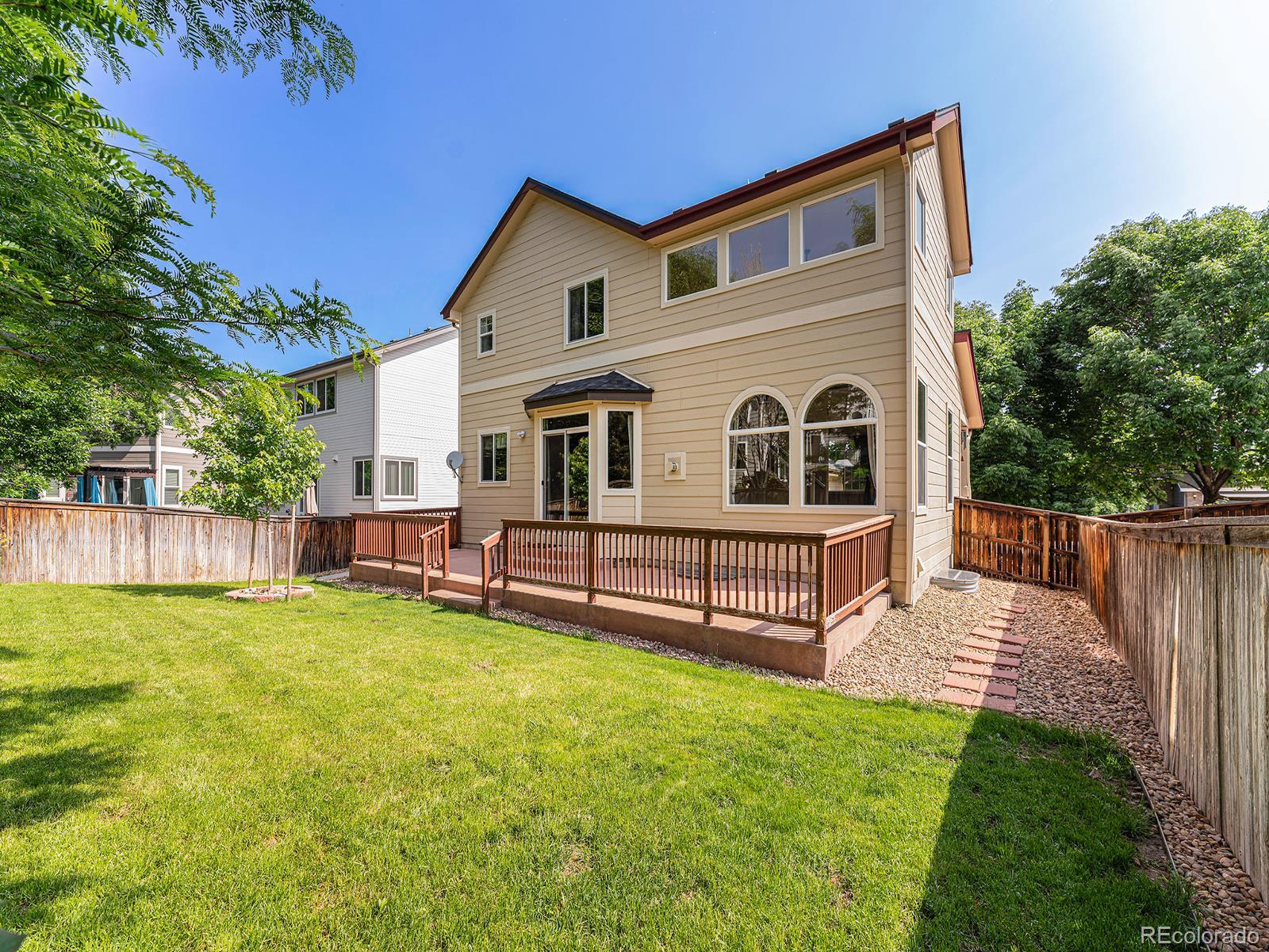 9911 Sylvestor Road Highlands Ranch, CO 80129 - Photo 29 of 31 a front view of a house with garden