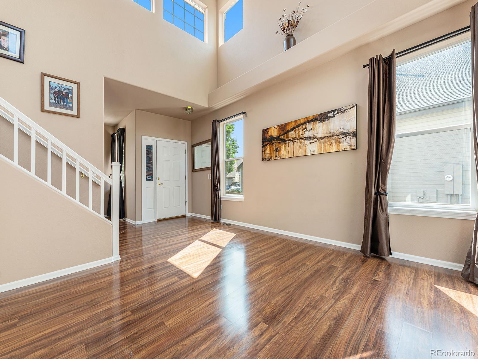 9911 Sylvestor Road Highlands Ranch, CO 80129 - Photo 6 of 31 a view of a big room with wooden floor and windows