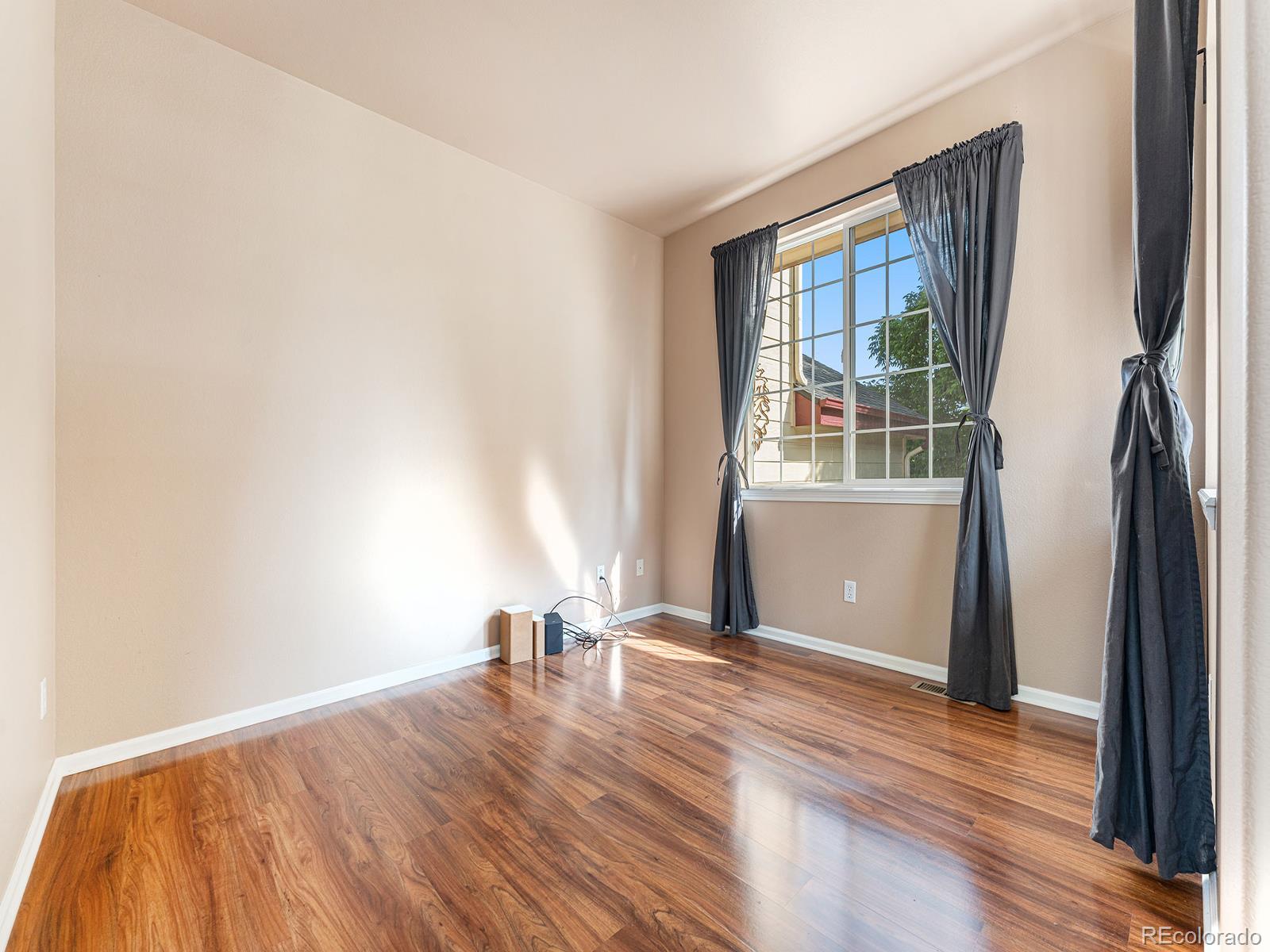 9911 Sylvestor Road Highlands Ranch, CO 80129 - Photo 7 of 31 a view of empty room with wooden floor and fan