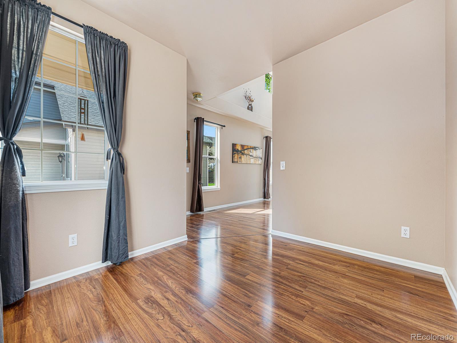 9911 Sylvestor Road Highlands Ranch, CO 80129 - Photo 8 of 31 a view of empty room with wooden floor and fan
