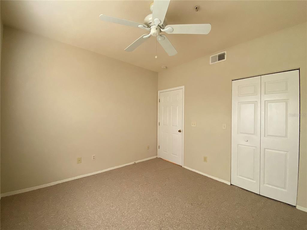 823 Camargo Way, Unit 302 Altamonte Springs, FL 32714 - Photo 12 of 19 an empty room with a ceiling fan and a window