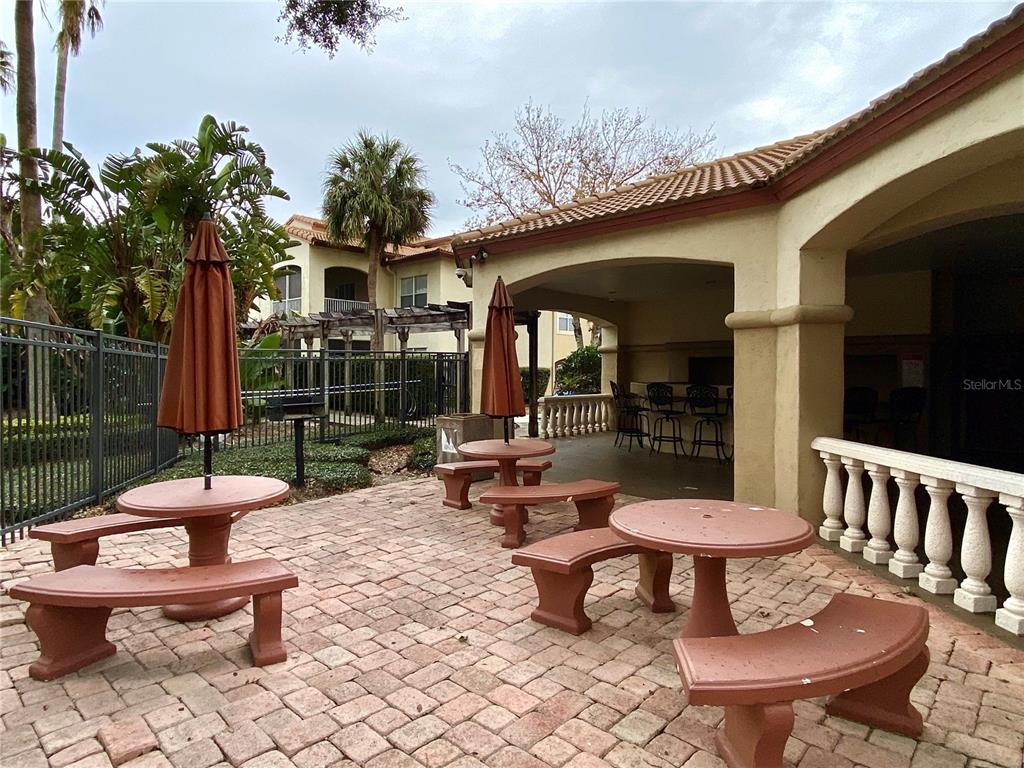 823 Camargo Way, Unit 302 Altamonte Springs, FL 32714 - Photo 17 of 19 a view of a patio with a dining table and chairs with a potted plants and a table