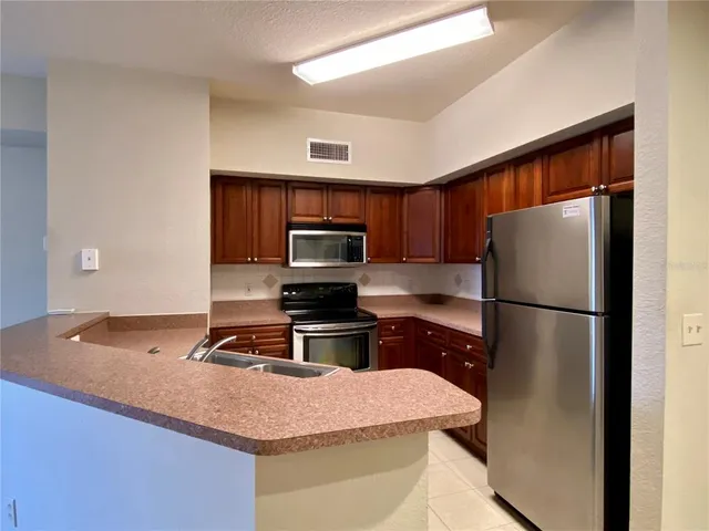 a kitchen with a refrigerator sink and microwave