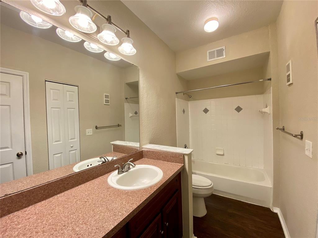 823 Camargo Way, Unit 302 Altamonte Springs, FL 32714 - Photo 9 of 19 a bathroom with a granite countertop sink a toilet and shower