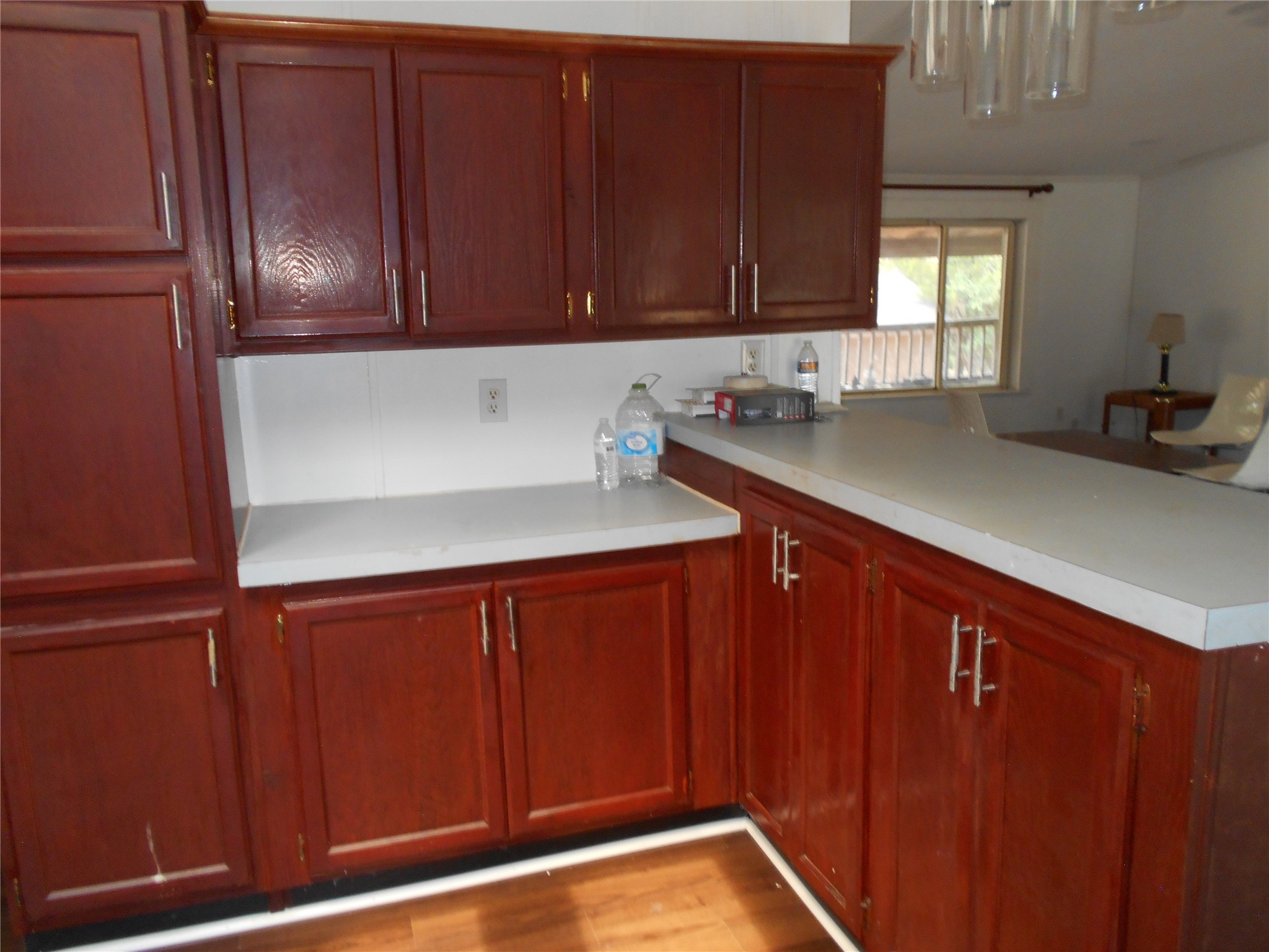8001 Burleson Manor Road Manor, TX 78653 - Photo 15 of 31 A well-appointed kitchen features rich wood cabinetry and ample counter space, extending into a breakfast bar.