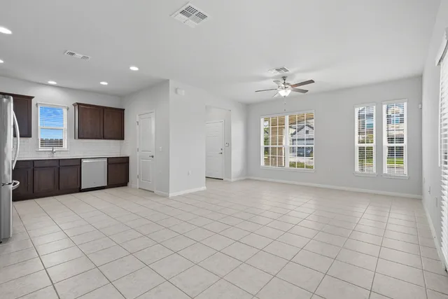 a view of an empty room with a kitchen
