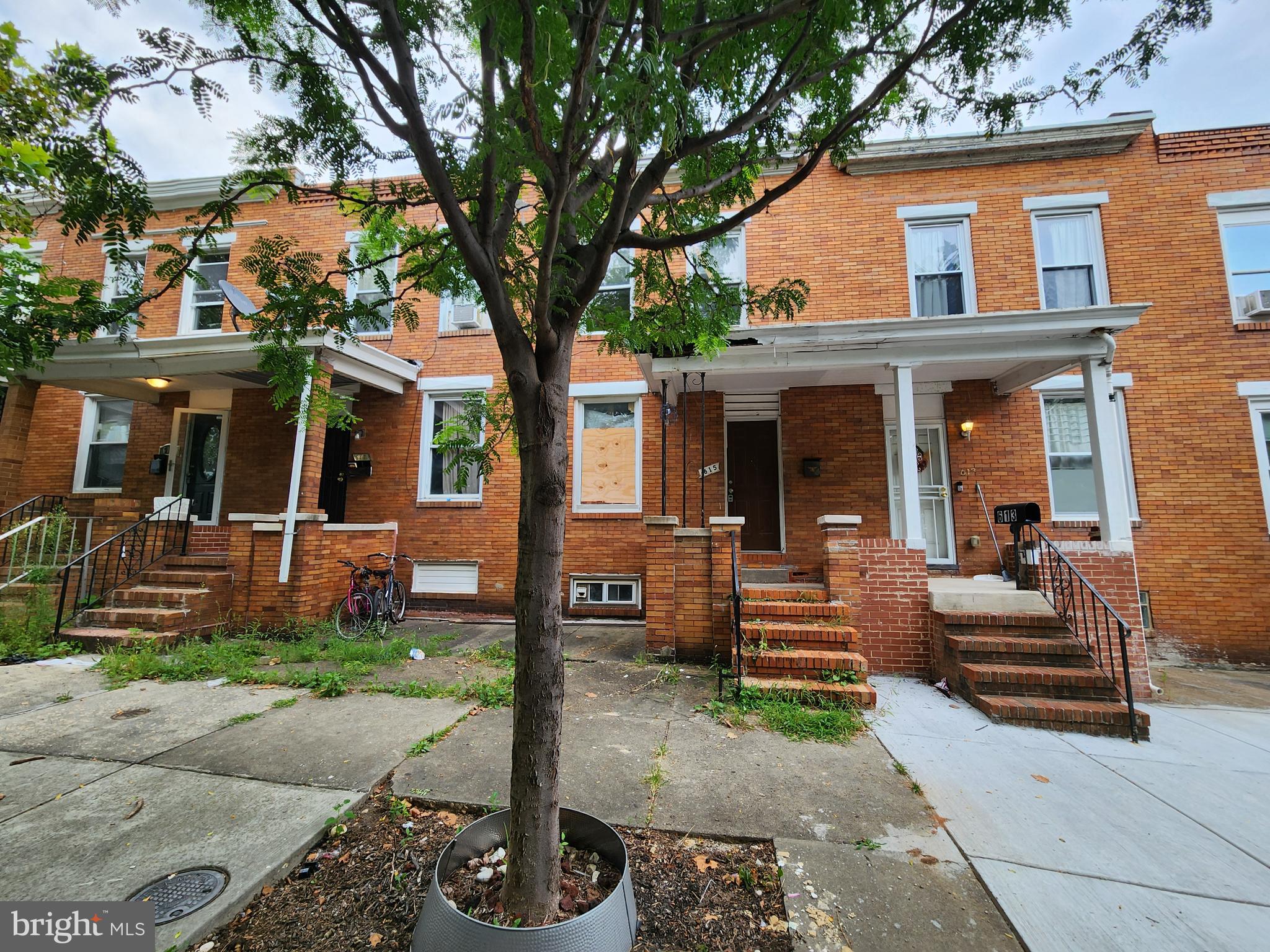 a front view of a house with garden and porch