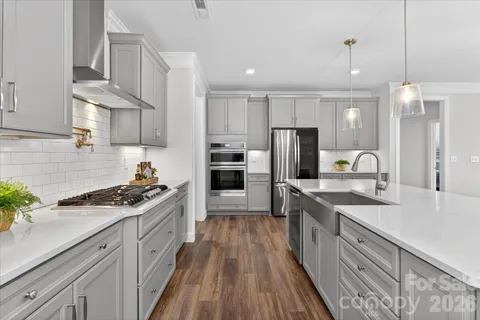 a kitchen with stainless steel appliances a sink stove and refrigerator