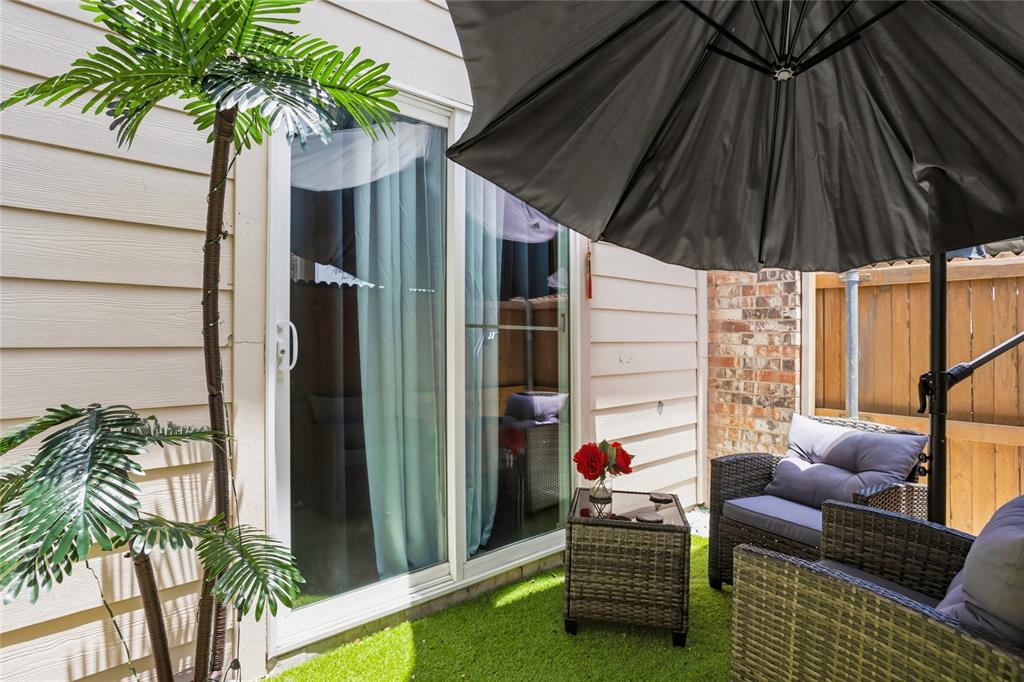 5540 Boca Raton Boulevard, Unit 181 Fort Worth, TX 76112 - Photo 5 of 21 Fenced in patio area with access through sliding doors to the kitchen. Cute set up with cozy chairs and a umbrella for shade!