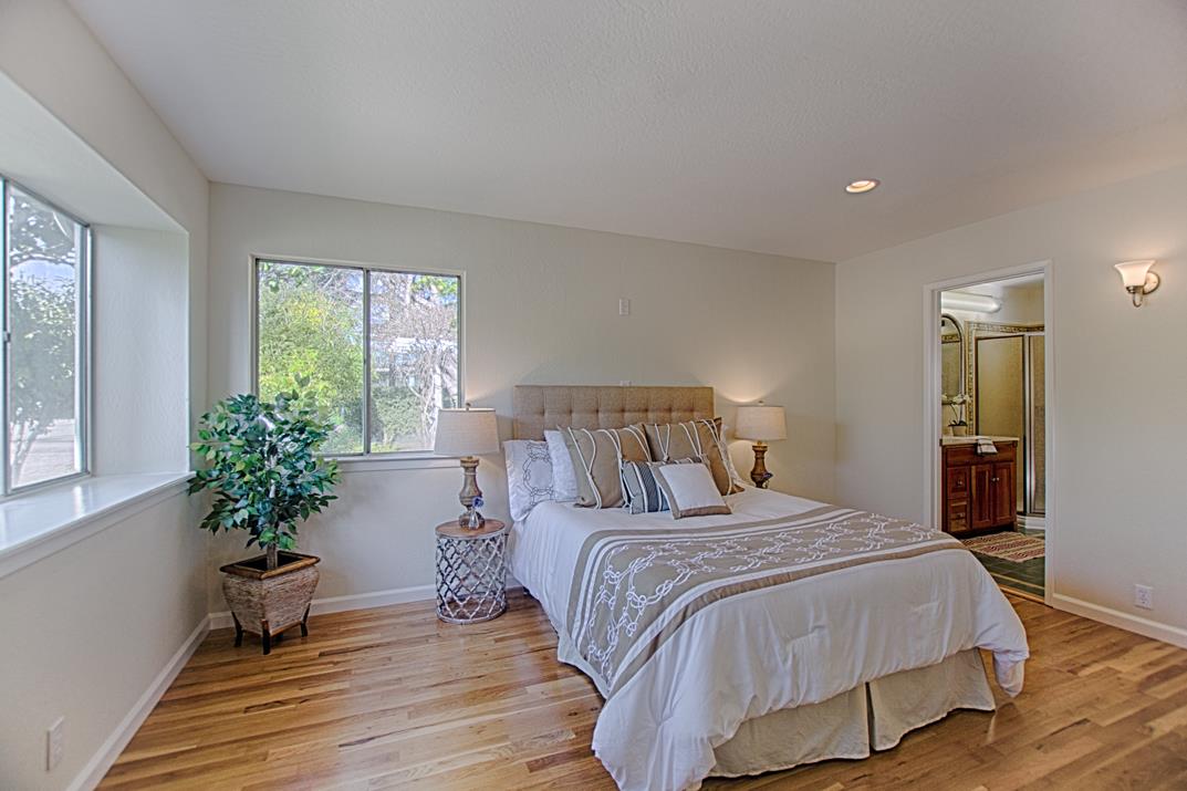 716 Rosedale Avenue Capitola, CA 95010 - Photo 11 of 19 a bedroom with a large bed and a potted plant