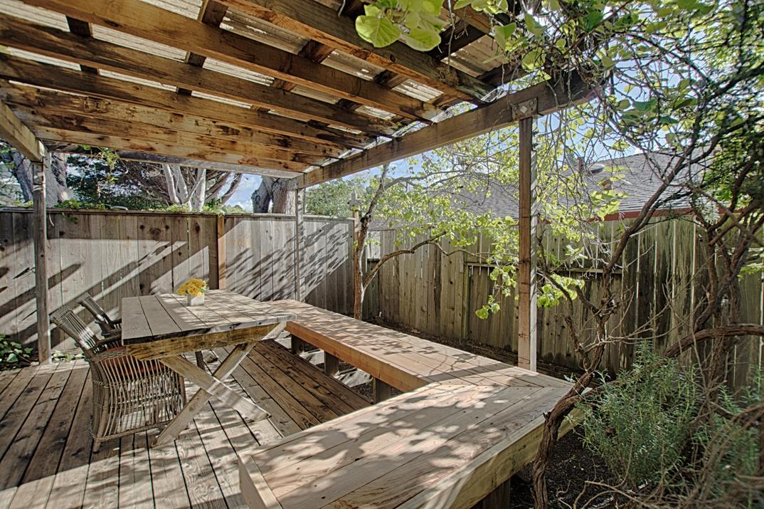 716 Rosedale Avenue Capitola, CA 95010 - Photo 16 of 19 a view of a backyard with table and chairs with wooden fence