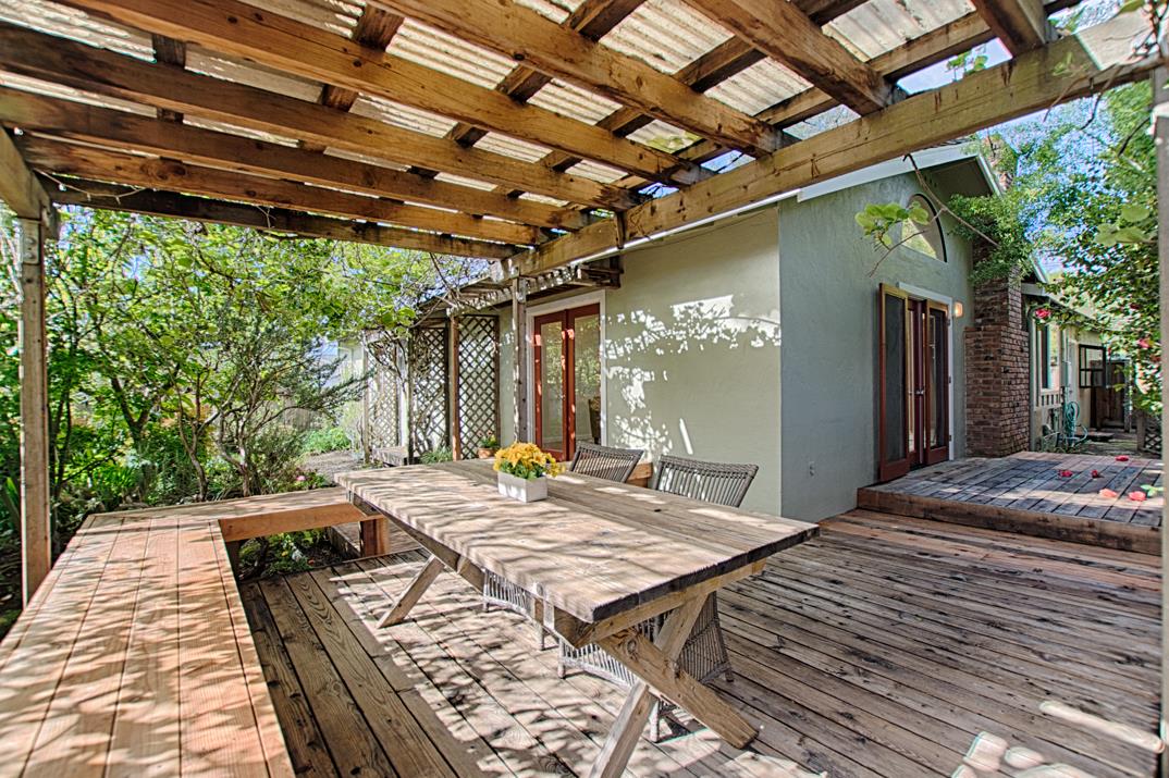 716 Rosedale Avenue Capitola, CA 95010 - Photo 18 of 19 a view of a backyard with table and chairs with wooden floor and fence