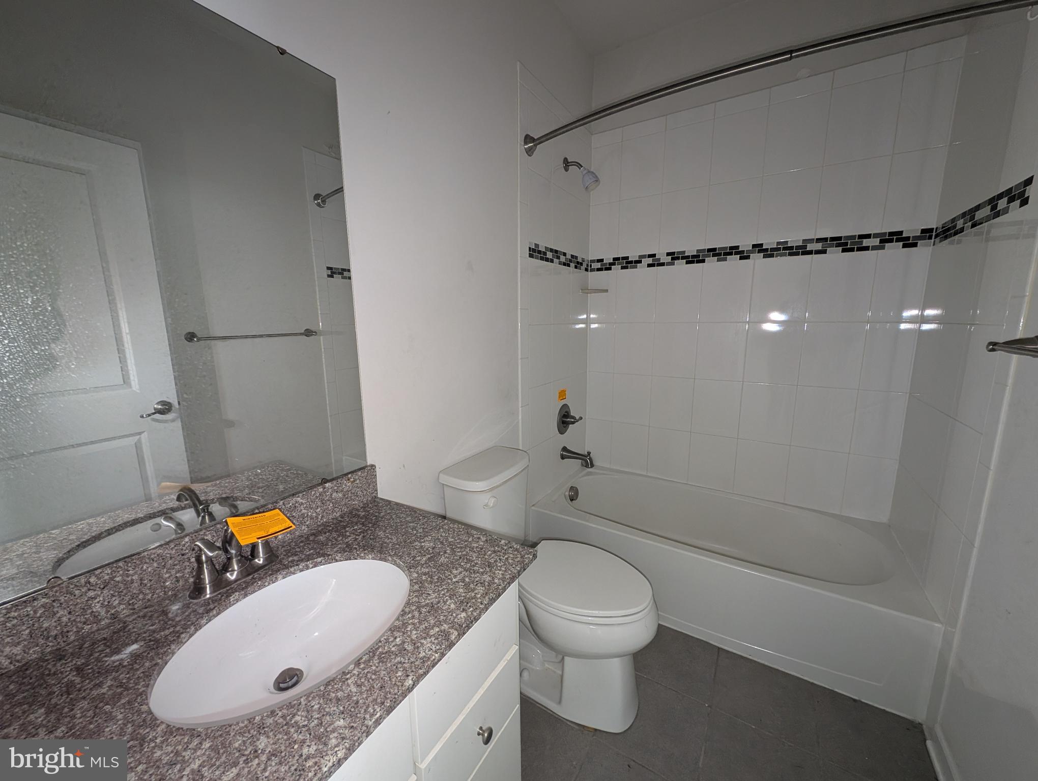 10018 Sandy Run Road Middle River, MD 21220 - Photo 11 of 17 a bathroom with a granite countertop sink toilet and shower