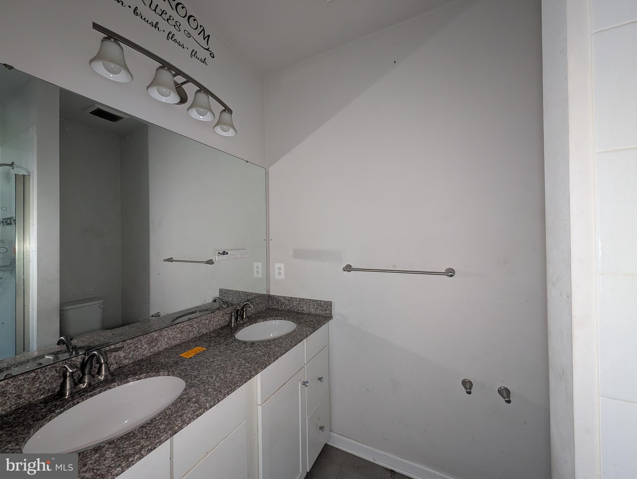 10018 Sandy Run Road Middle River, MD 21220 - Photo 8 of 17 a bathroom with a granite countertop sink and a mirror