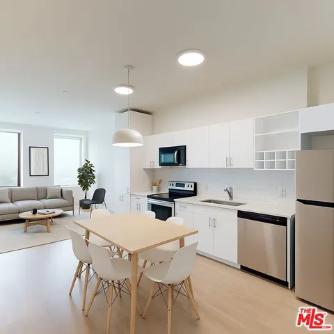 a kitchen with appliances a sink and cabinets