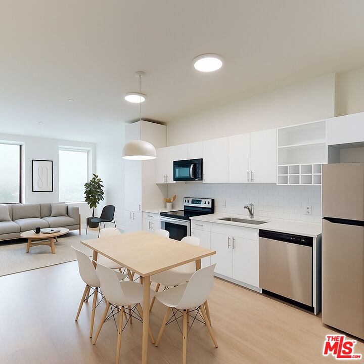 a kitchen with appliances a sink and cabinets