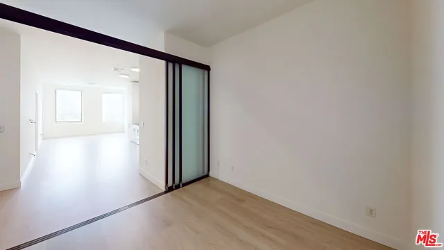an empty room with wooden floor and a window