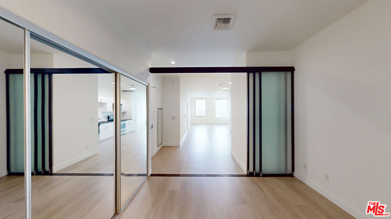 3810 Wilshire Boulevard, Unit 1108 Los Angeles, CA 90010 - Photo 5 of 15 a view of empty room with wooden floor