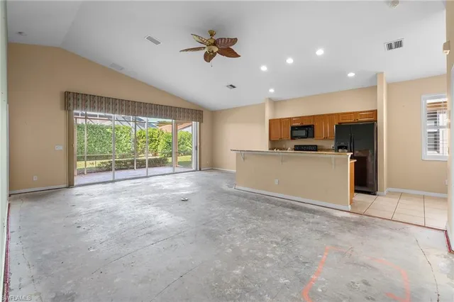 a view of kitchen with microwave stove top oven and cabinets