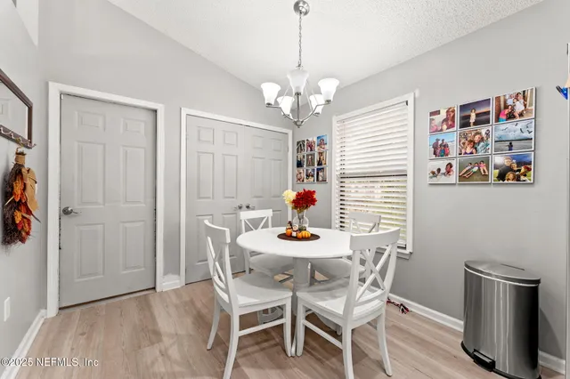a view of a dining room with furniture wooden floor and a chandelier