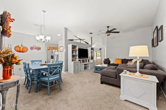 a living room with furniture a flat screen tv and a window