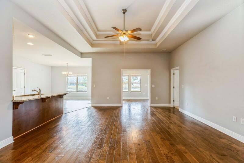 169 Windchime Way Freeport, FL 32439 - Photo 13 of 67 a view of an empty room with window and wooden floor