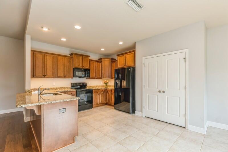 169 Windchime Way Freeport, FL 32439 - Photo 15 of 67 a kitchen with a stove a refrigerator and a sink